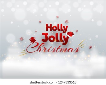 Holly Jolly Christmas lettering on winter background with bokeh light effect for greeting card design.
