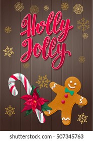 Holly Jolly.  Holiday greeting card with calligraphy and decorative elements. Handwritten modern lettering with candy cane, holly and gingerbread man on dark wooden background.