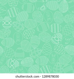 Holy Easter seamless background. Hand drawn eggs with ornaments on a light green spring background. Vector illustration. 