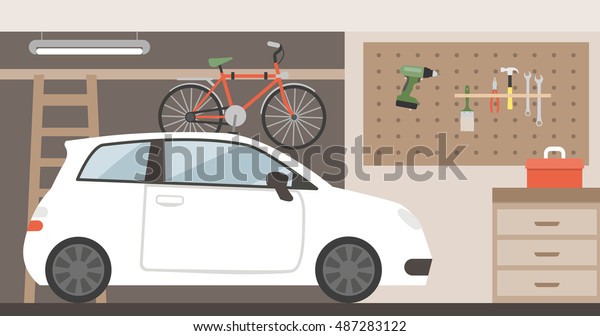 Home\
garage with car, bike and tools hanging on the\
wall