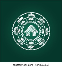 home icon inside chalk emblem written on a blackboard