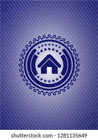 home icon inside emblem with denim texture