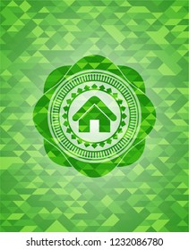 home icon inside green emblem with mosaic background