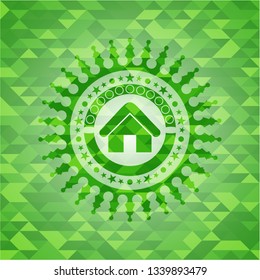 home icon inside green emblem with triangle mosaic background