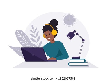 Home office concept, black woman with headphones and laptop working from home, student or freelancer.