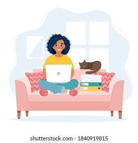 Home office concept, woman working from home sitting on a sofa, remote work concept