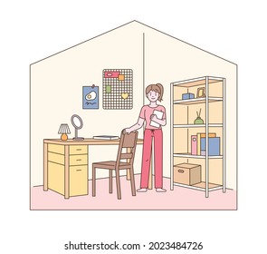 Home office interior. A woman is standing in front of her desk in her her room. outline simple vector illustration.