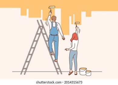 Home renovation and repairing concept. Young couple man and woman standing backwards painting wall in new apartment in yellow vector illustration