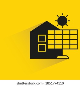 home and solar panel with shadow on yellow background