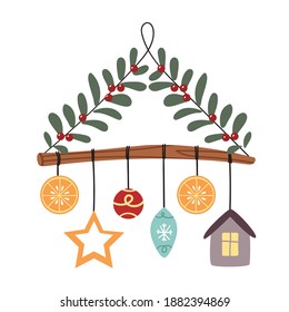 Homemade Christmas decor with twigs, cranberries and orange on a branch.