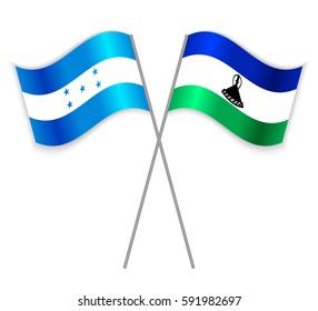 Honduran and Basotho crossed flags. Honduras combined with Lesotho isolated on white. Language learning, international business or travel concept.