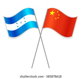Honduran and Chinese crossed flags. Honduras combined with China isolated on white. Language learning, international business or travel concept.