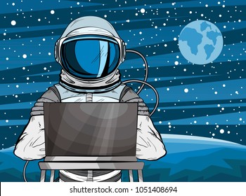 Hooded hacker Astronaut behind a laptop in pop art style. Cosmonaut on Mars planet surface