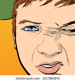 Hooligan boy gets angry, grimacing an angry face.