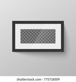 Horizontal black blank picture frame with transparent place for photo on gray wall