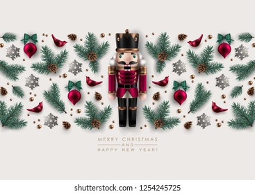 Horizontal Christmas Border made of Nutcracker, Realistic Pine Branches, Glass Christmas Ornaments and Glitter Snowflakes. Flat lay, top view.