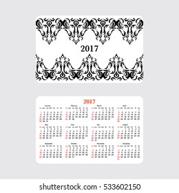 Horizontal pocket calendar for 2017 year. Week starts Sunday. Double-sided calendar for 2017 year. Yearly calendar template with text 2017 and damask classic pattern..