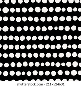 Horizontal spot stripes seamless repeat pattern. Irregular, vector polka dots in row all over surface print on black background.