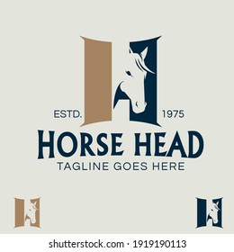 Horse Head letter H symbol in negative space style. like a stable doors in between as the shape of letter H.