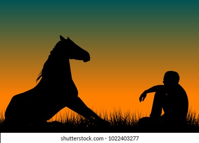 Horse and man silhouettes sitting on grass at sunset
