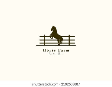 Horse silhouette behind wooden fence paddock for vintage retro rustic countryside western country farm ranch logo design