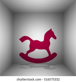 Horse toy sign. Bordo icon with shadow in the room.