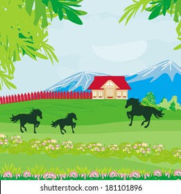 Horses grazing in a pasture with mountains