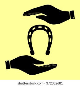 Horseshoe sign. Save or protect symbol by hands.