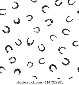 Horseshoe vector seamless pattern. Horse shoe silhouette as international good luck symbol. Endless background with fortune and success signs