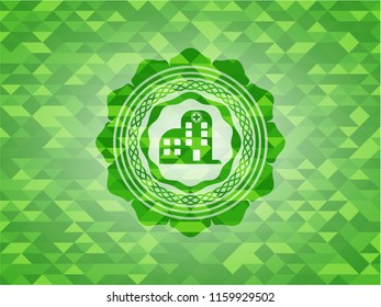 hospital icon inside green mosaic emblem