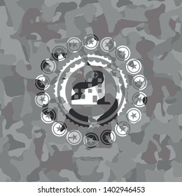 hospital icon inside grey camouflage emblem