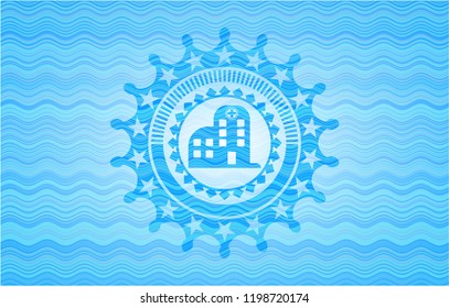 hospital icon inside light blue water style badge.