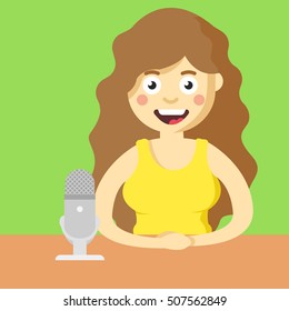 Host girl with microphone at the table, in tv show.