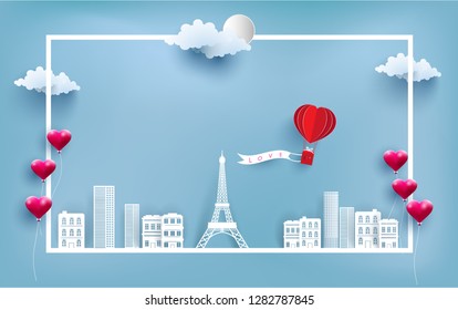 hot air balloon carrying love banners flying over the city and eiffel tower. paper art design. happy valentine's day