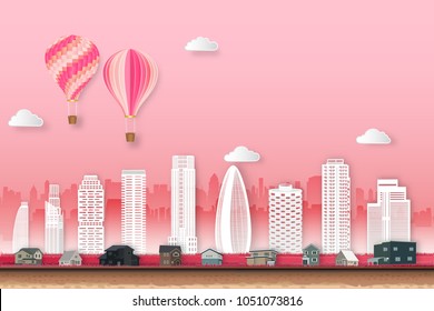The hot air balloon and cityscape on pink sky as love, happy valentine's day, wedding, paper art and craft style concept. vector illustration.