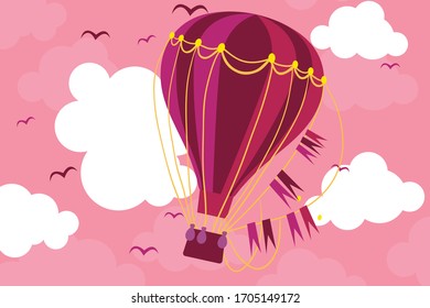 hot air balloon with clouds and a blue sky the the background