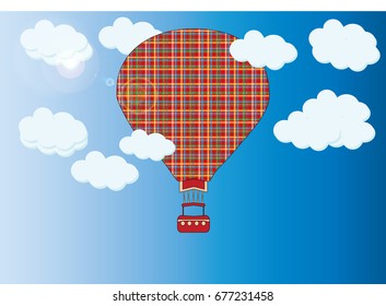 Hot air balloon in the sky with clouds.