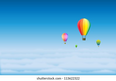 Hot air balloons hovering high on top of the clouds.