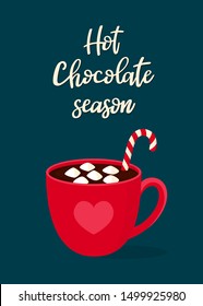 Hot chocolate with marshmallow in a red mug on a dark blue background. Handwritten text "Hot Chocolate Season". Hygge postcard, greeting card, poster 