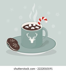Hot cocoa mug with deer logo on the cup and marshmallows, caramel cane, chocolate cookies on the plate. Snowflakes on the background. Christmas drink.
