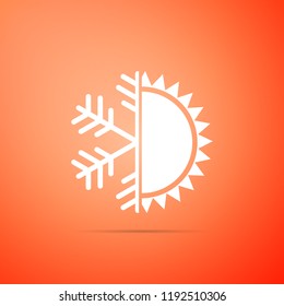 Hot and cold symbol. Sun and snowflake icon isolated on orange background. Winter and summer symbol. Flat design. Vector Illustration
