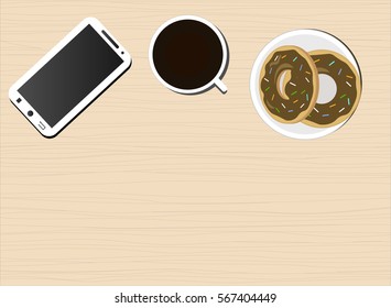 Hot cup of black coffee, baked goods (donuts) and a telephone on the wooden background. View from above. Lunch.