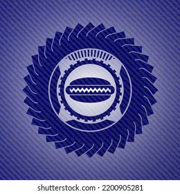hot dog icon inside emblem with denim texture. 