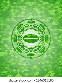 hot dog icon inside green emblem. Mosaic background