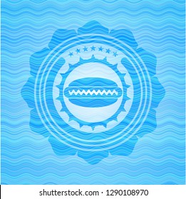 hot dog icon inside light blue water wave badge background.