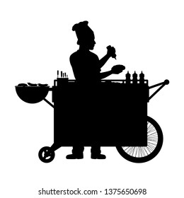 Hot dog seller with his street food cart silhouette vector