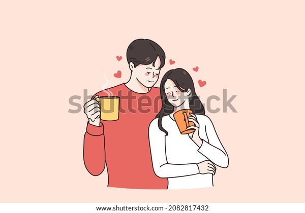 Hot drinks and love\
concept. Young loving smiling couple man and woman standing holding\
cups mugs with hot tea or coffee enjoying time together vector\
illustration 