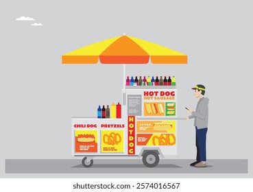 a hotdog stall with yellow and red color with umbrella and moving wheels selling sodas hotdog chilli dog and pretzels run by young man