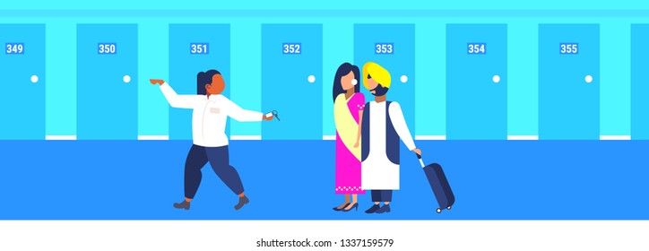 hotel manager leading indian guests hospitality staff concept receptionist showing room welcoming arriving man woman tourists couple in traditional clothes horizontal