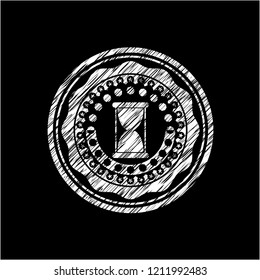 hourglass icon drawn on a blackboard